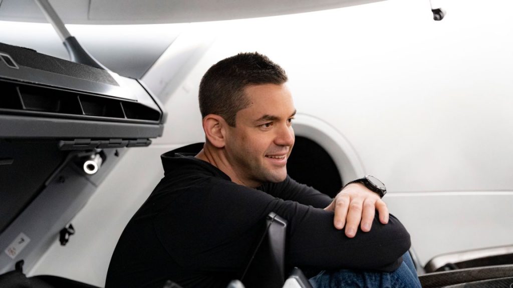 In a stunning comeback, Jared Isaacman is renominated to lead NASA A young man smiles while sitting amidst machinery.